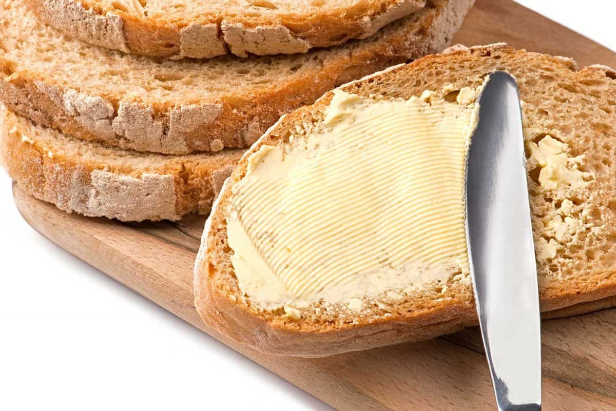A knife spreading butter on bread
