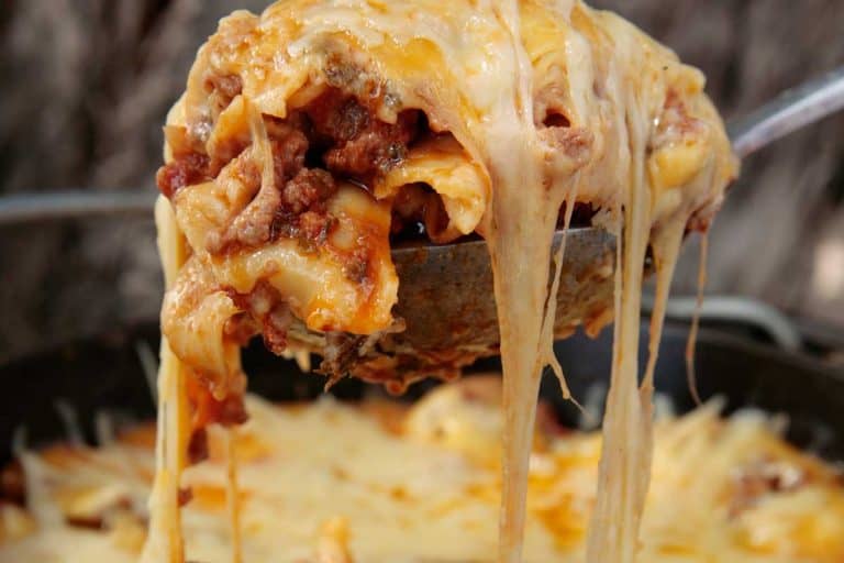 A serving of lasagna is scooped from the dish, What's The Best Cheese For Lasagna?