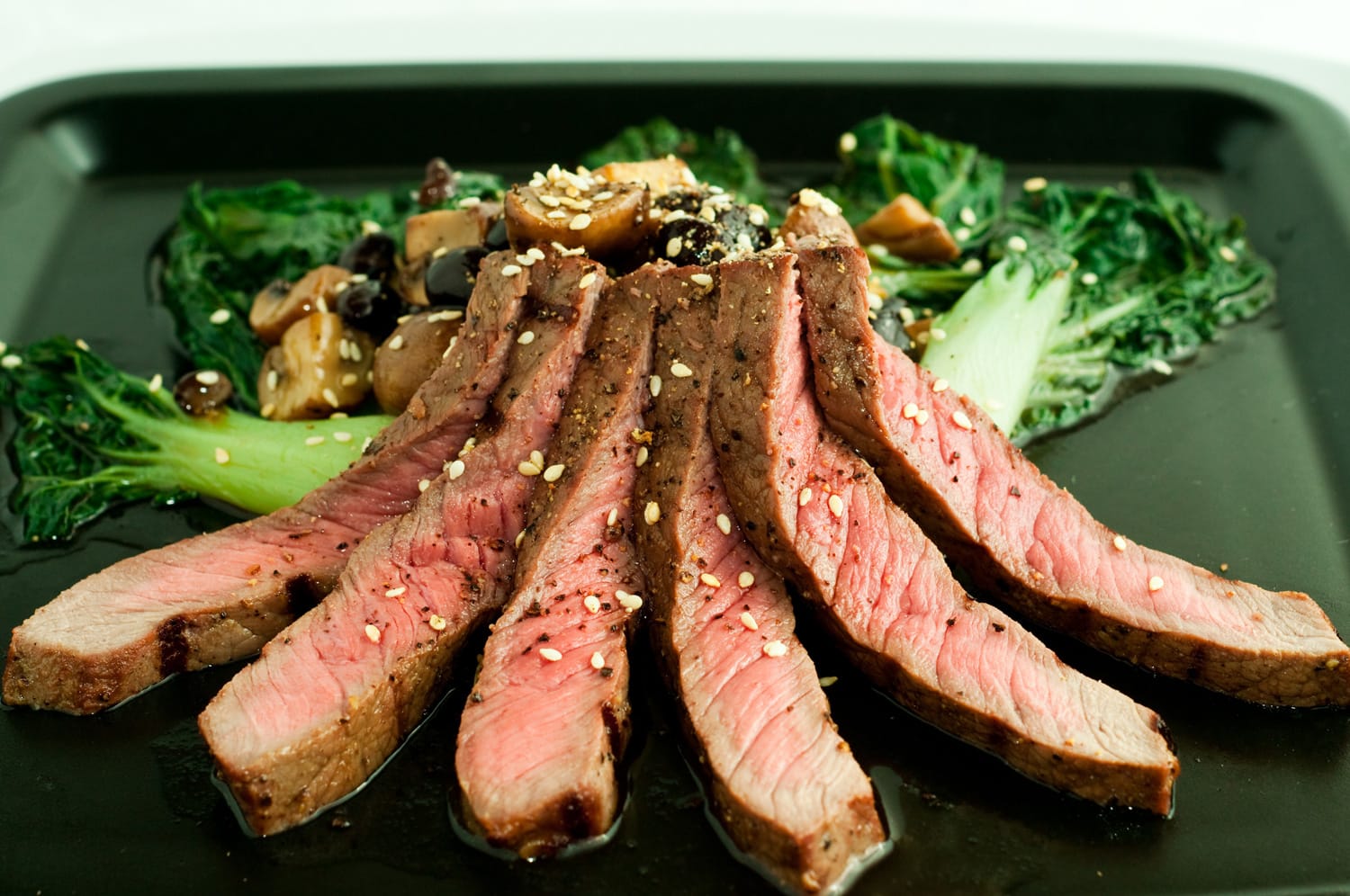 Asian styled grilled steak with bok choy and mushrooms in black bean sauce
