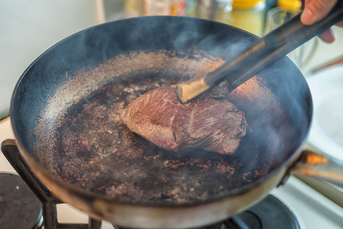 Cooking a delicious cut of rump steak on a hot searing pan