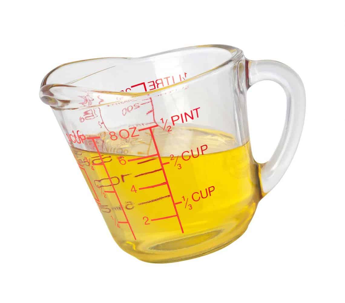 Cooking oil in measuring cup with a clipping path