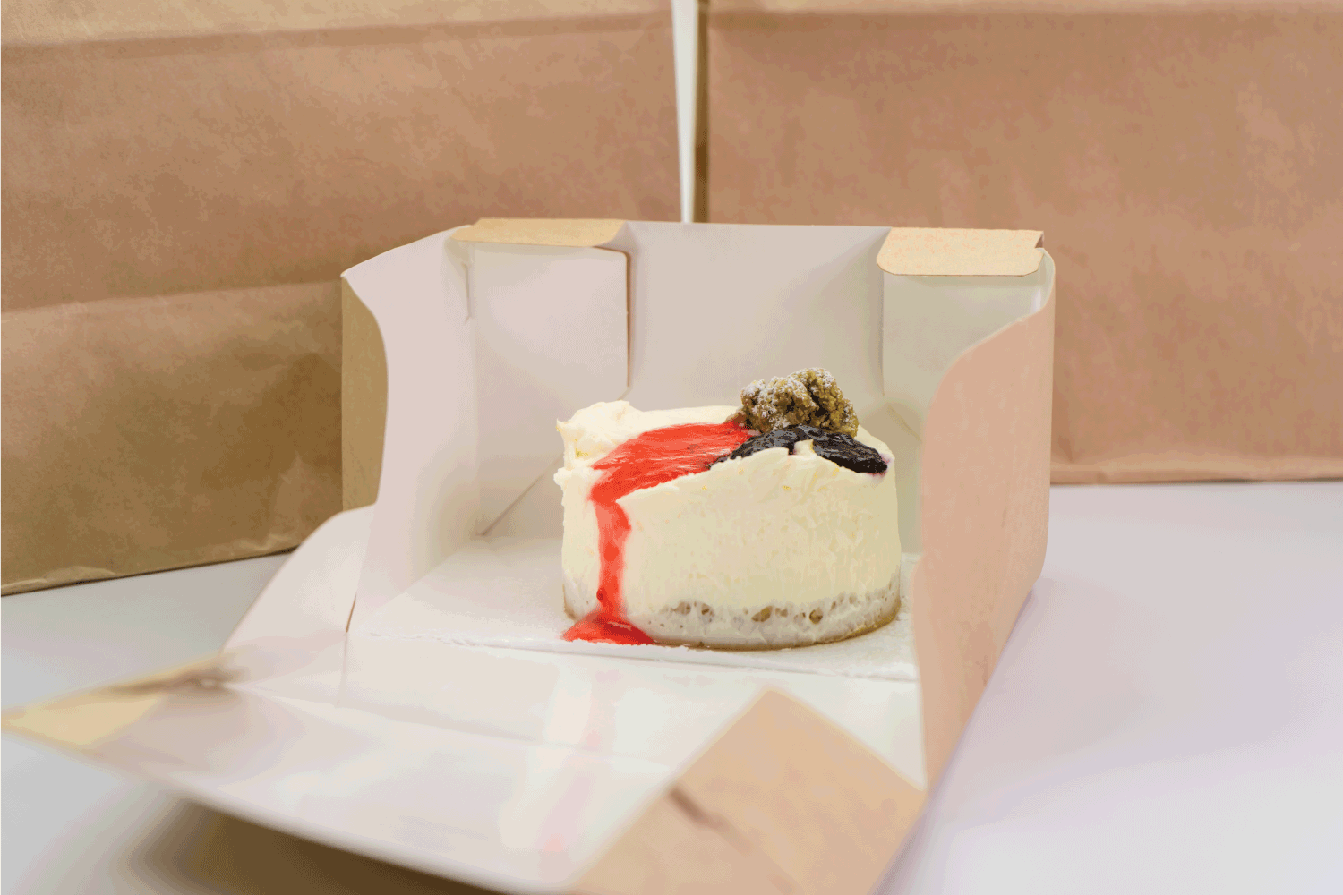 Delicious cheesecake in eco packaging, food and dessert delivery concept.