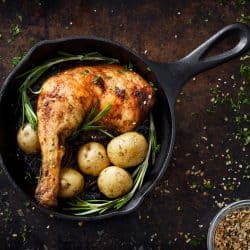 Delicious fried chicken cooked in a frying pan with oregano and potatoes, Should You Butter Turkey Or Chicken Before Roasting?