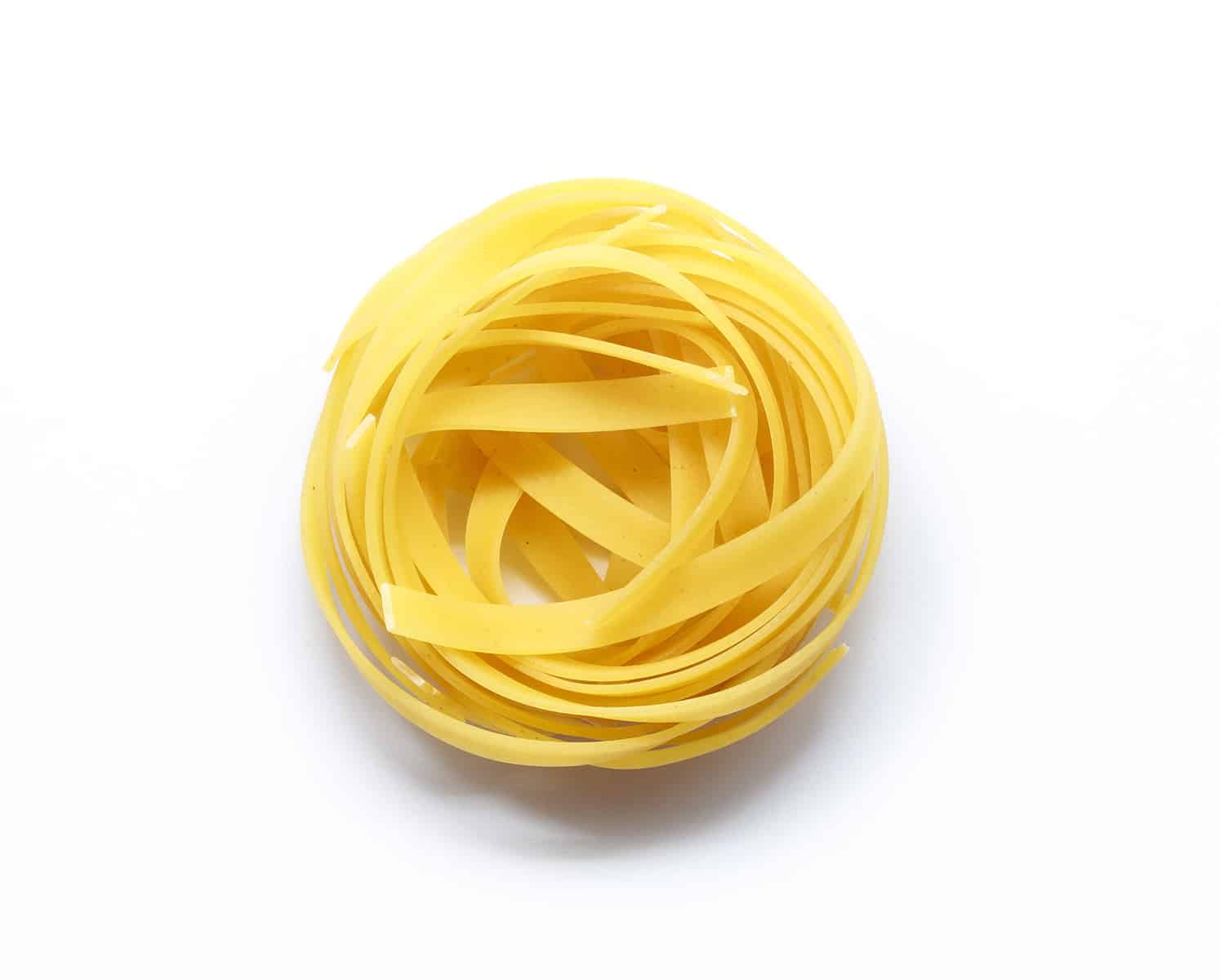 Fettuccine italian pasta isolated on white background