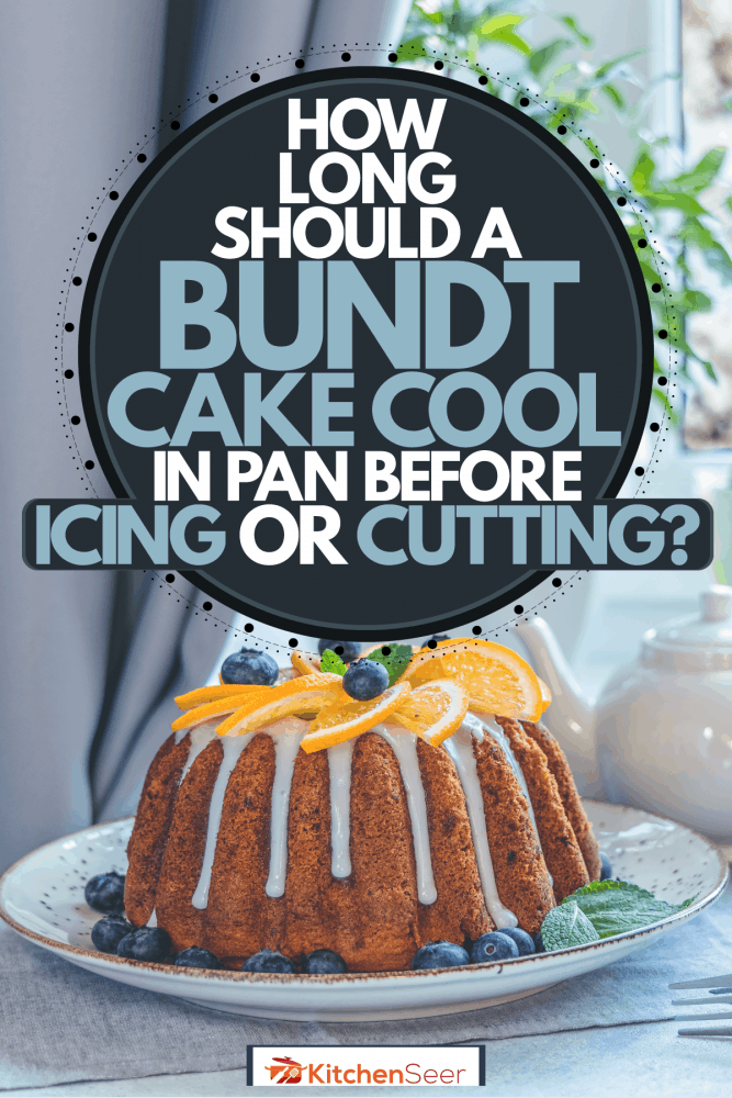 A delicious bundt cake topped with oranges and blue berries, How Long Should A Bundt Cake Cool In Pan Before Icing Or Cutting?