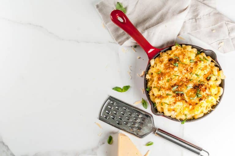 Mac and cheese, american style macaroni pasta with cheesy sauce and crunchy breadcrumbs topping, in portioned pan, white marble table, Can You Make Mac And Cheese Without Butter?