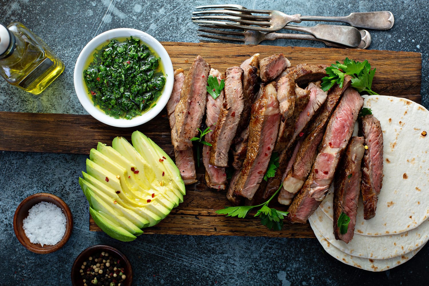 Mexican steak with avocado, tortillas and green sauce