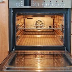 Modern kitchen with open oven with lights on, Do Convection Ovens Cook And Bake Faster?