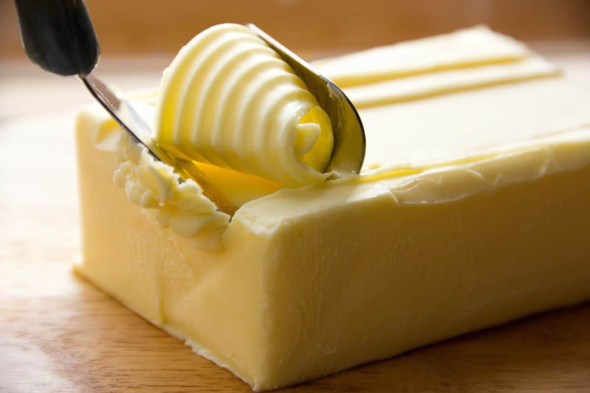Scooping delicious unsalted butter using a scoop