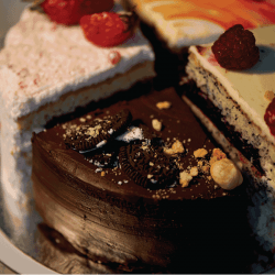 The different pieces of the cake smoothly rotate on the base. There is chocolate, carrot, yogurt and berries. 30 Types Of Cake Every Foodie Should Know