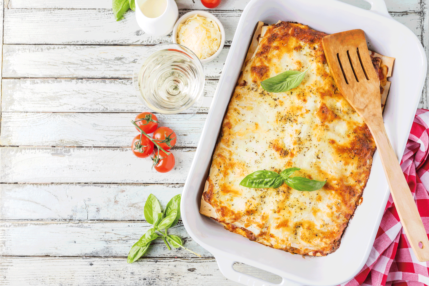 Traditional italian lasagna with vegetables, minced meat and cheese. On a wooden background. Top view
