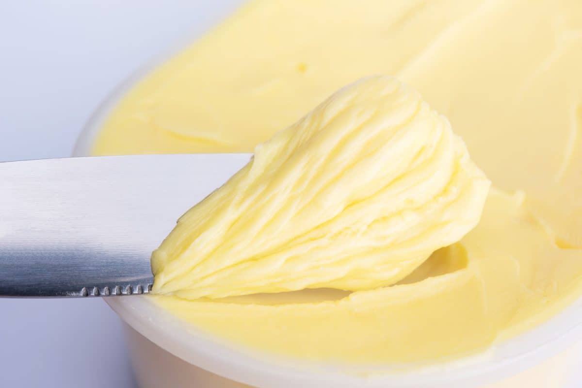 Using a butter knife for scooping cheese butter or margarine