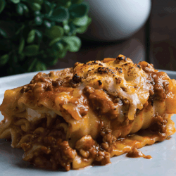 stacked layers of flat pasta, ground beef tomato sauce, cream and cheese. How Long Should You Cook Lasagna [Including The Pasta Noodles & Time In Oven]