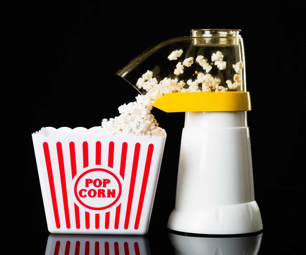 A hot air popcorn popper in process of making popcorn
