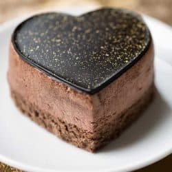 A luxurious chocolate mousse cake decorated with gold dust on a gold brocade tablecloth, How To Properly Store A Mousse Cake Overnight