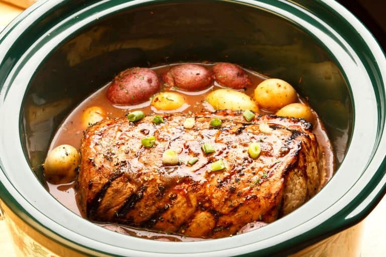 A pot of roast garnished with potatoes and chives, What's The Best Beef For Pot Roast?