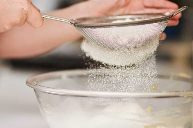 Cropped shot of a woman sifting flour into a glass bowl, Can You Over-Sift Flour?