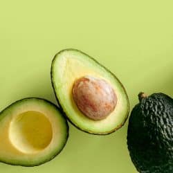 Fresh organic hass avocados on a green background, top view with copy space, Does Microwaving An Avocado Soften It?