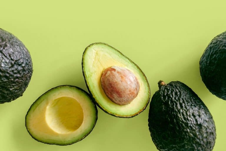 Fresh organic hass avocados on a green background, top view with copy space, Does Microwaving An Avocado Soften It?