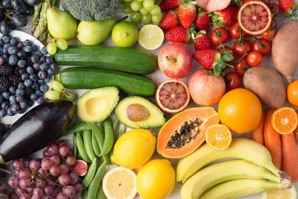 Healthy eating, assortment of fruits and vegetables in rainbow colours background, top view, selective focus