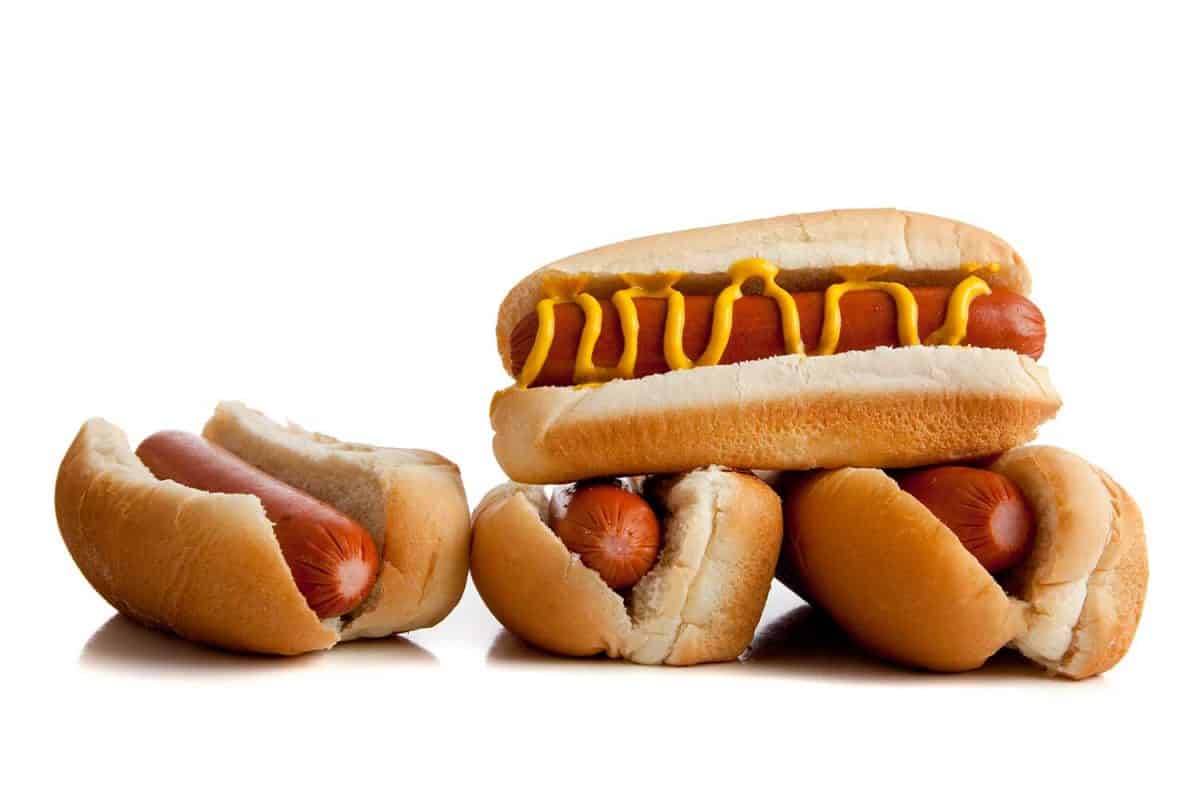 Hot dogs with mustard on white background
