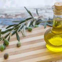 Olive oil in glass and olive on cutting board, What Oil Is Best For Butcher Block Or A Cutting Board?