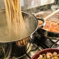 Pasta being cooked in a large stainless steel pot, What's The Best Pot For Cooking Pasta?