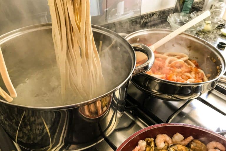 Pasta being cooked in a large stainless steel pot, What's The Best Pot For Cooking Pasta?