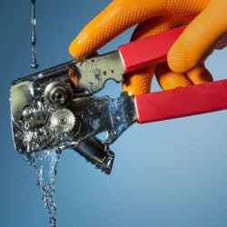 Rinsing a can opener. Action is stopped in this high speed photograph, How To Clean A Can Opener