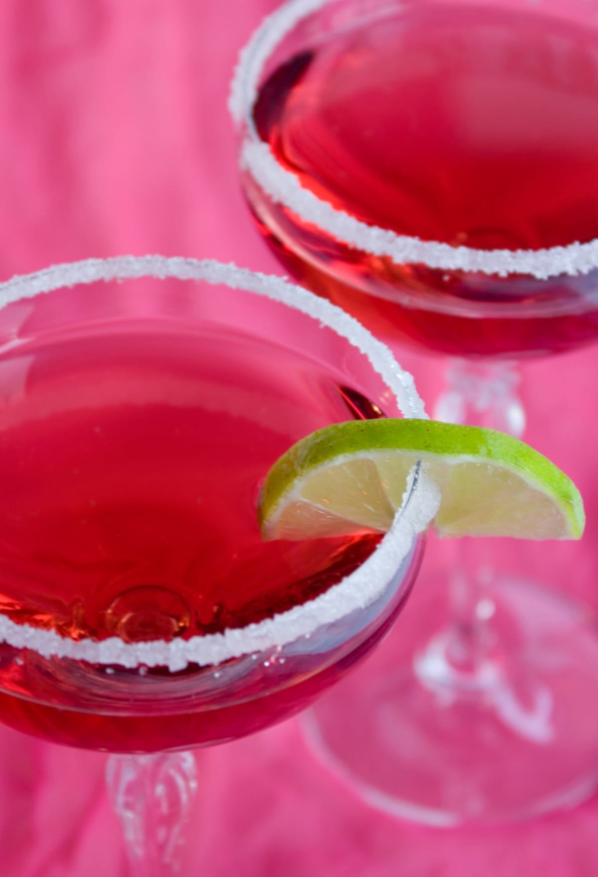 sugar rimmed pink cocktails with lime wedge 