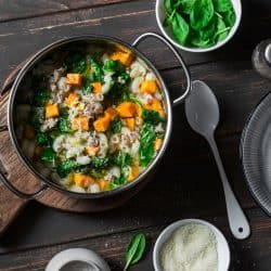 Sweet potato and pork sausage soup with spinach and pasta in a pot on dark background, top view, What Is The Best Pot For Making Soup?