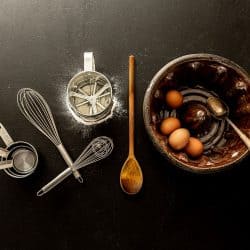 Vintage ceramic bundt cake mould and kitchen utensils on black chalkboard background, Are Bundt Pans Non-Stick?
