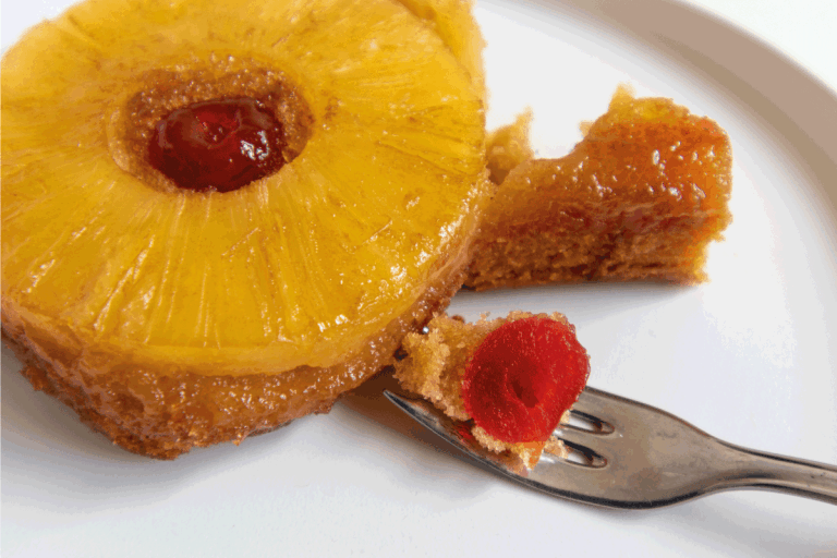 close-up-of-a-slice-of-pineapple-upside-down-cake-on-a-white-plate-with-fork.-How-To-Store-Pineapple-Upside-Down-Cake