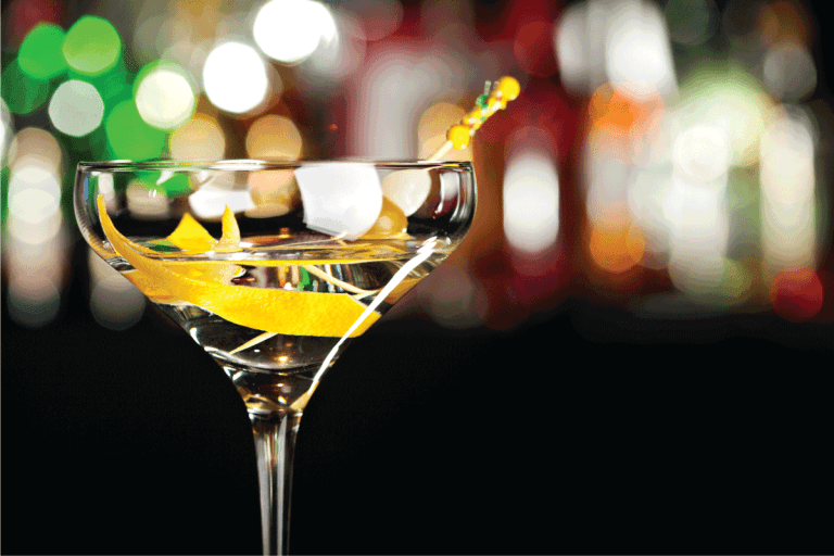 martini glass with drink and orange peel on a bokeh background. What Is The Right Size For A Martini Glass