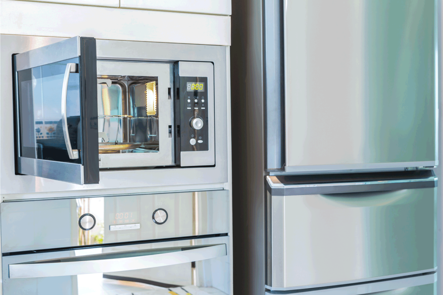 modern kitchen with stainless steel polished microwave and refrigerator