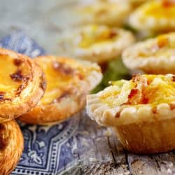 A collage of Mini Quiche with Bacon and Cheddar Cheese and Portugal egg tart Pastel de Nata with azulejo tile, What's The Difference Between Quiche And Tart?