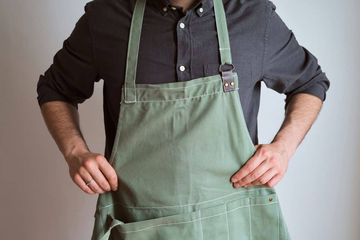 A man in a kitchen apron. Chef work in the cuisine. Cook in uniform, protection apparel
