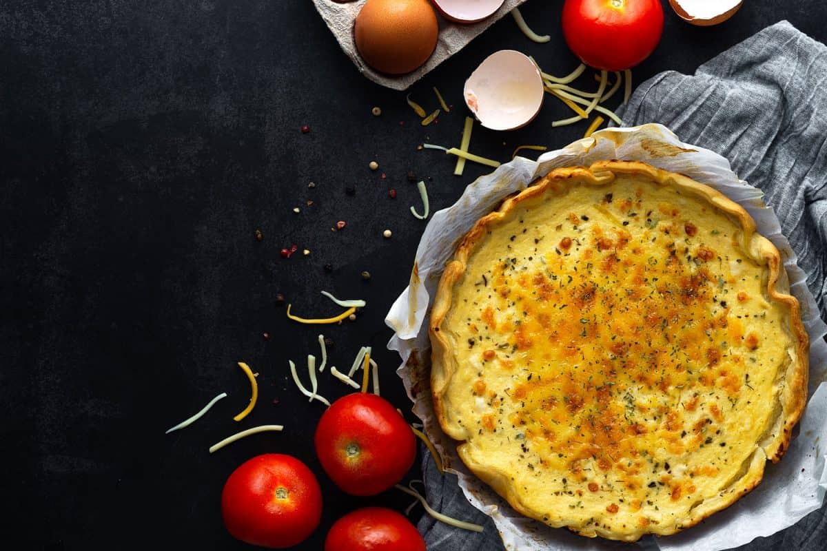 A vegetable quiche with cheese, tomatoes, and eggs