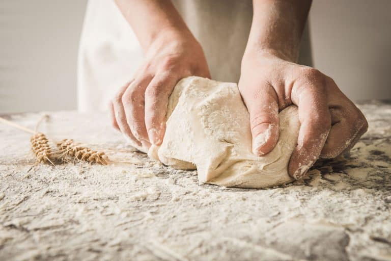 A woman kneading a dough on the table, Can You Knead Dough With A Rolling Pin?