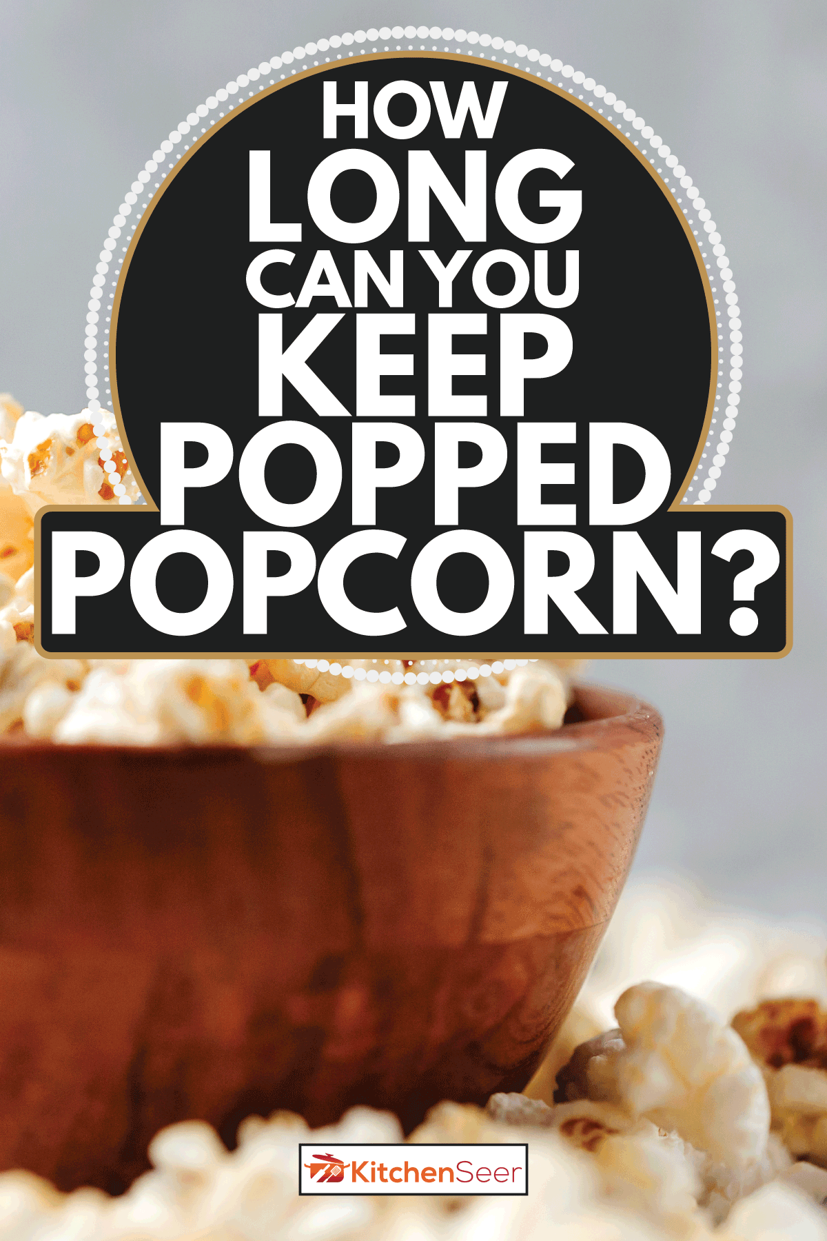 A wooden bowl of salted popcorn on rustic grey table. How Long Can You Keep Popped Popcorn