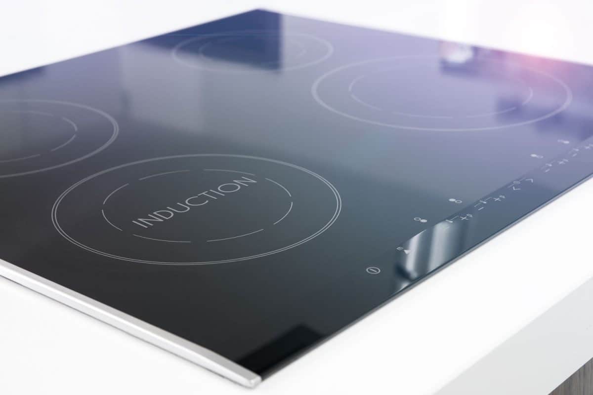 An induction cooktop on a white granite
