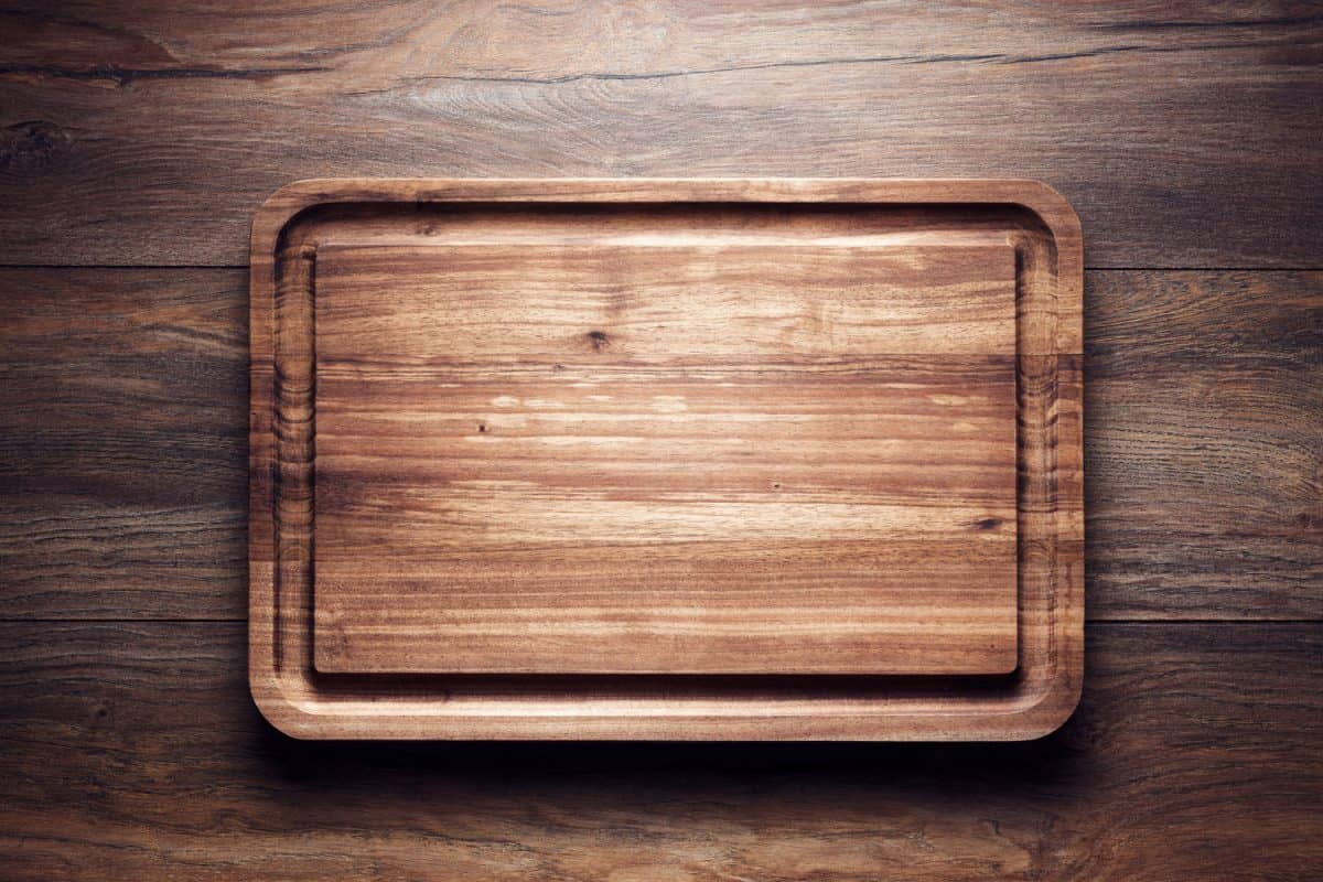 An up close and detailed photo of a wooden chopping board