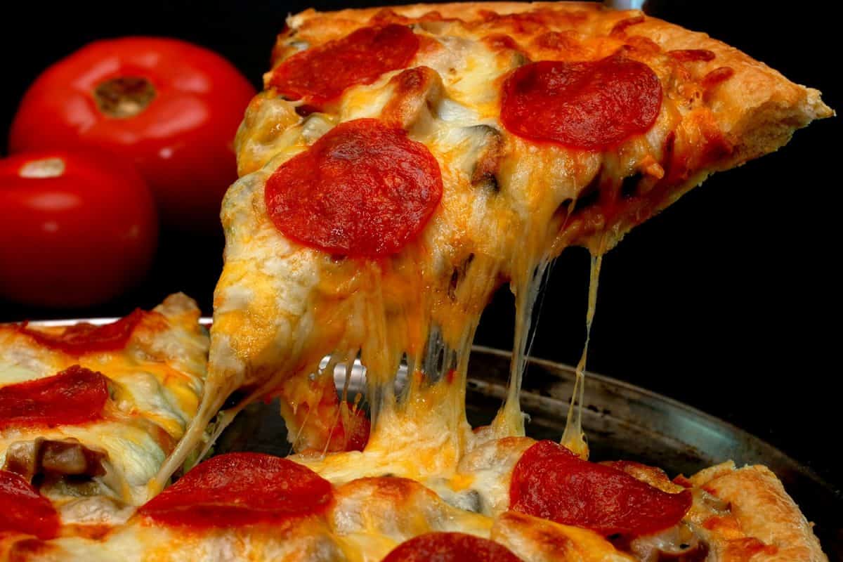 An up close photo of a greasy pepperoni pizza
