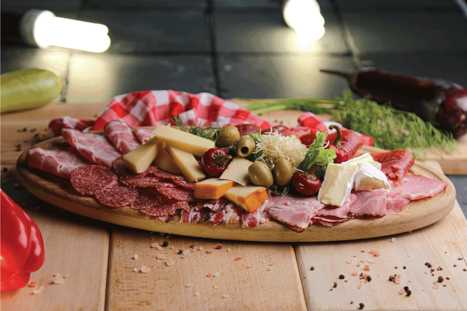 Antipasto appetizer platter with ham, salami, olive, brie cheese, goat cheese. charcuterie board