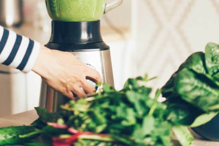Close up woman hands making green smoothie in blender bowl in interior of kitchen, Can A Blender Chop Vegetables?