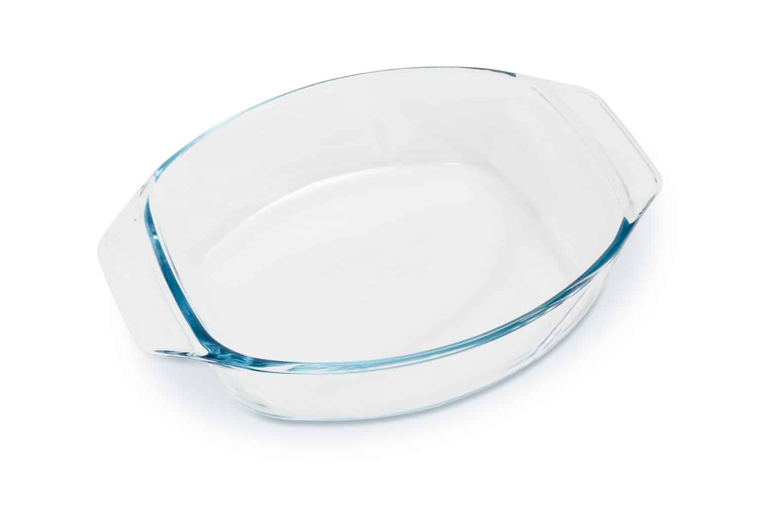 Empty oval glass casserole pan on a white background
