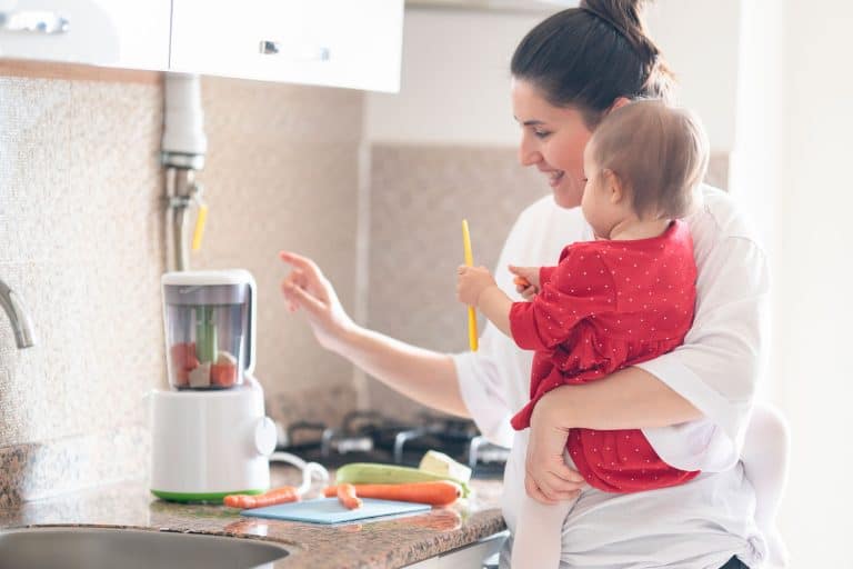 Mother is showing a blender to her little daughter. Little daughter is watching to blender., Is A Blender Good For Making Baby Food?