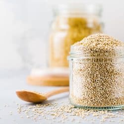 Raw quinoa grains in jar. Healthy vegetarian food on gray kitchen table, How Long Can You Keep Quinoa In The Pantry?