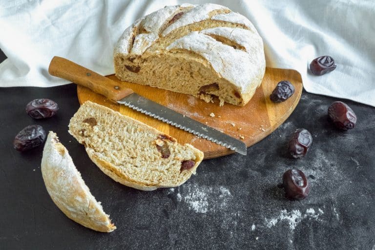 Sliced fresh bread with dates and bread knife, Do You Need To Wash A Knife After Cutting Bread? [And Other Care Tips For Bread Knife]