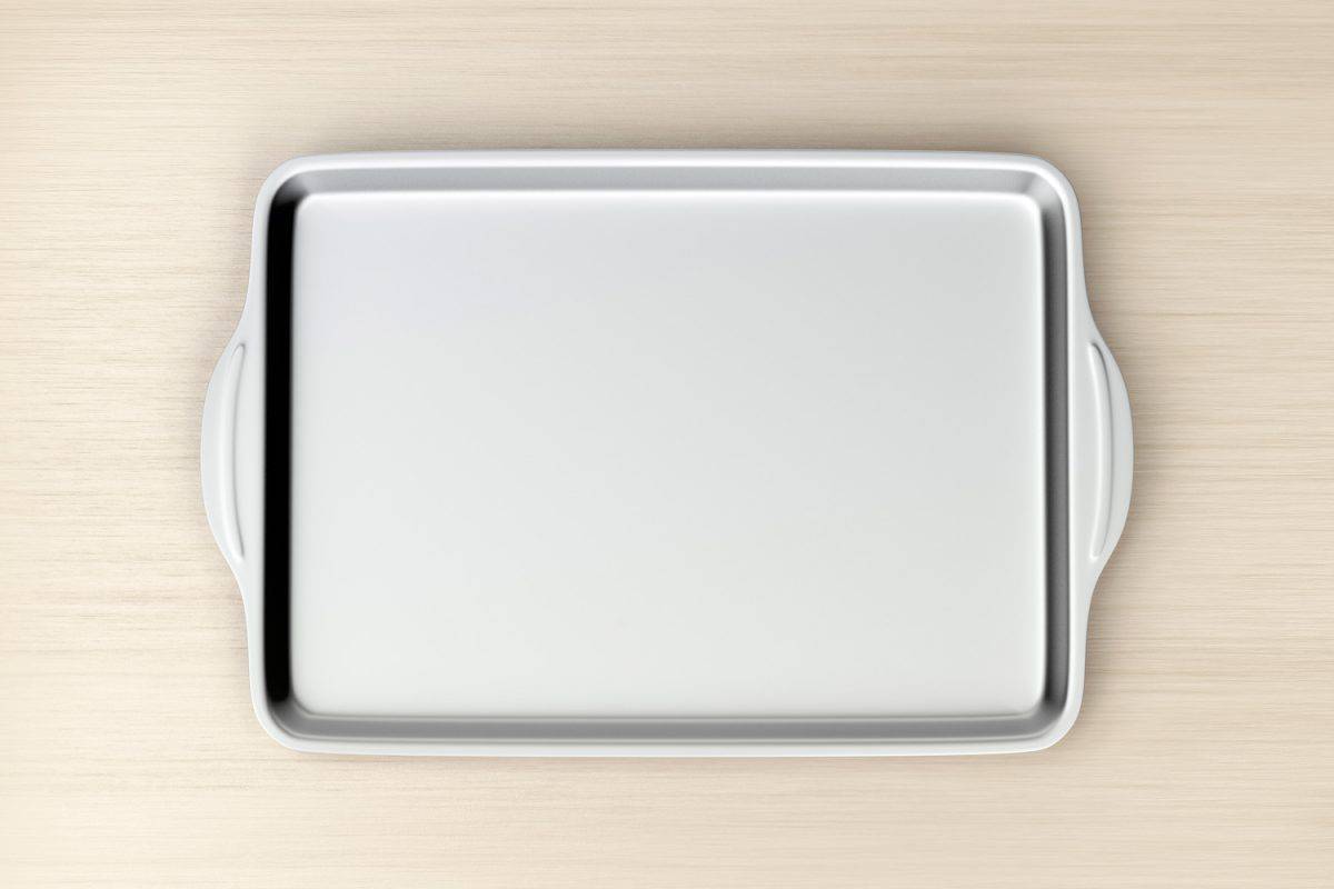 Stainless steel baking pan on wood table, top view